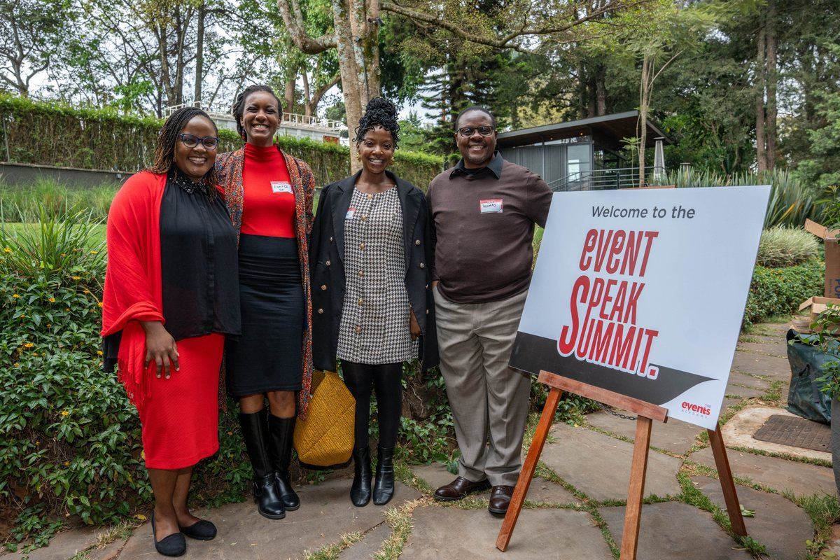 Delegates beside the Event Speak Summit welcome sign in Nairobi